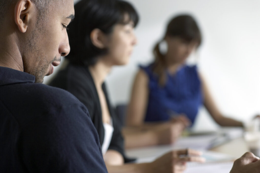 Three people in a business meeting.