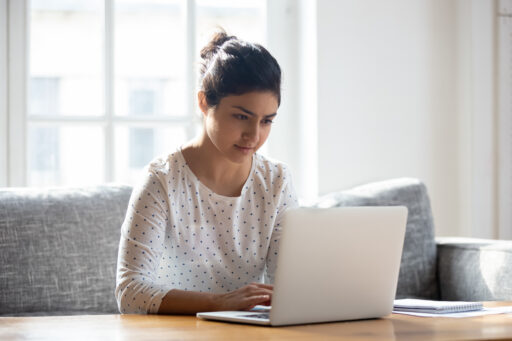 A woman using a laptop.